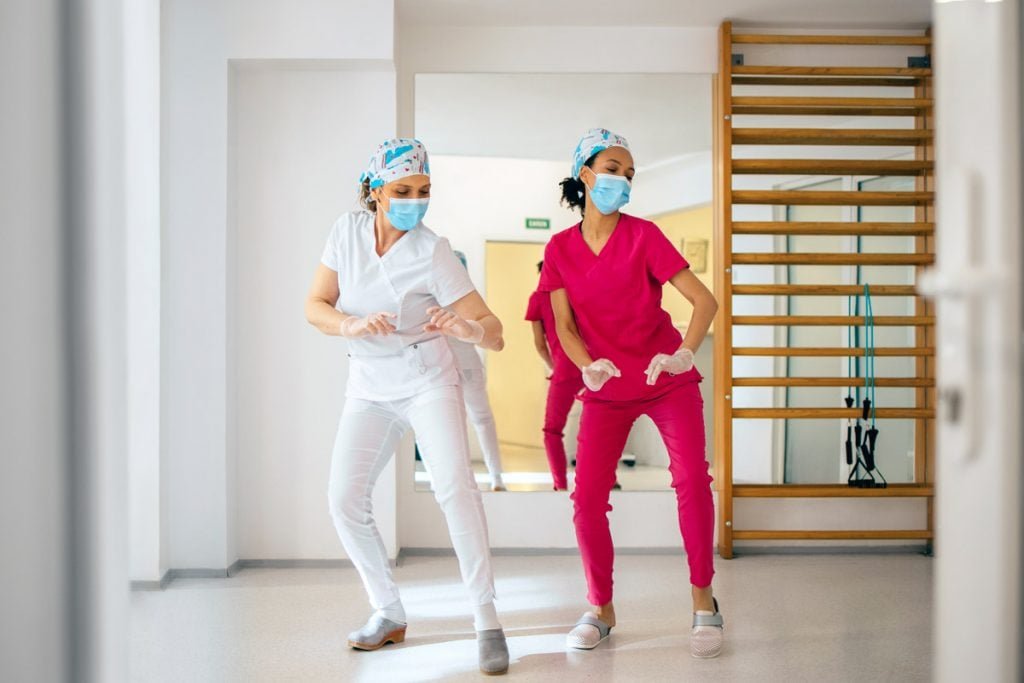 Two nurses dance.